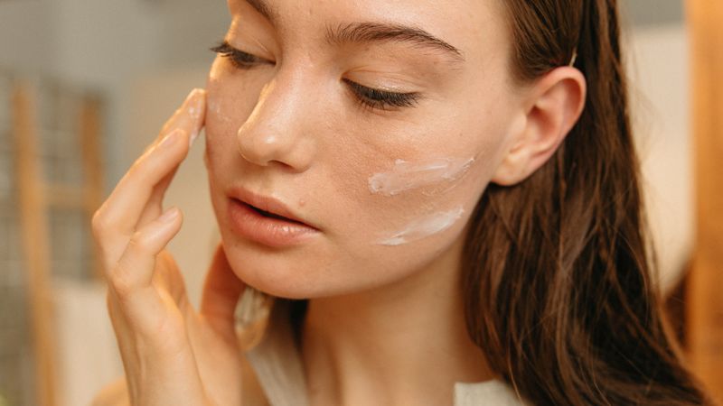 Skincare cream being applied to the face
