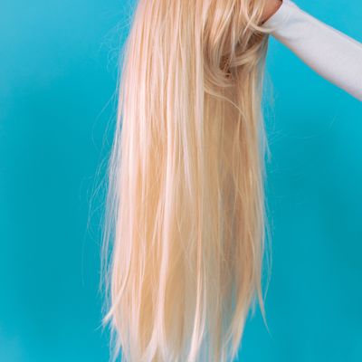 A wig being fitted and adjusted at the mirror