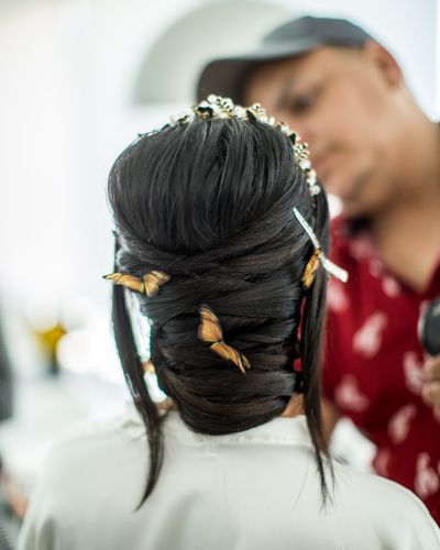 Hands pinning a bride's hair into an updo