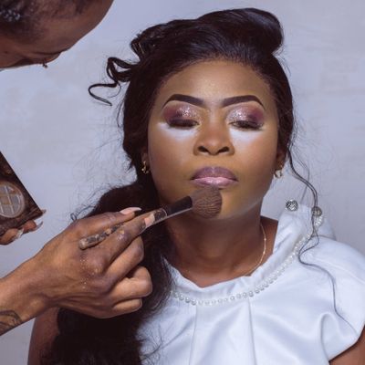 A makeup brush blending soft glam eyeshadow