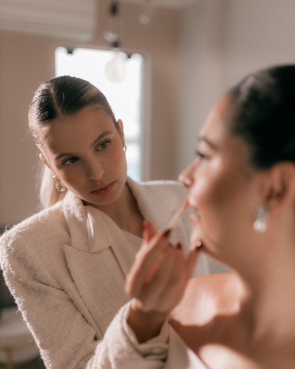 A makeup artist finishing a bridal look