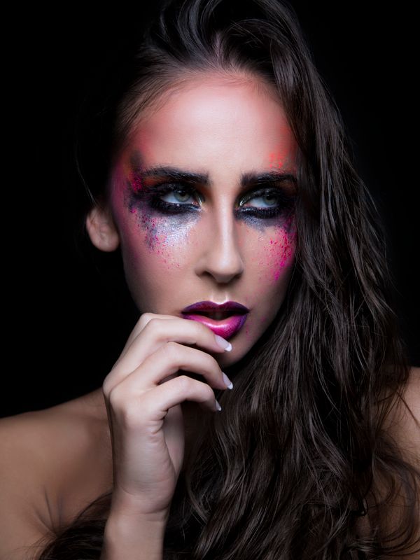 An editorial makeup look with bold colour