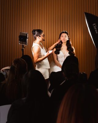 A makeup artist applying bridal makeup