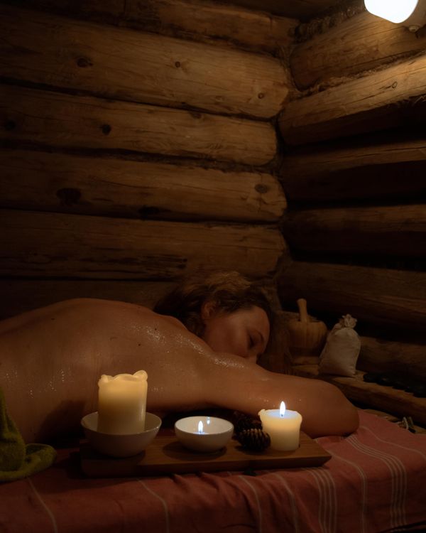 A sauna lit by soft candlelight