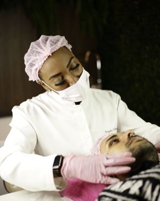 A skin therapist performing a treatment
