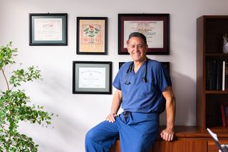 A practitioner in scrubs in the clinic