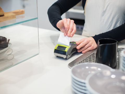 An employee taking a card payment on a terminal